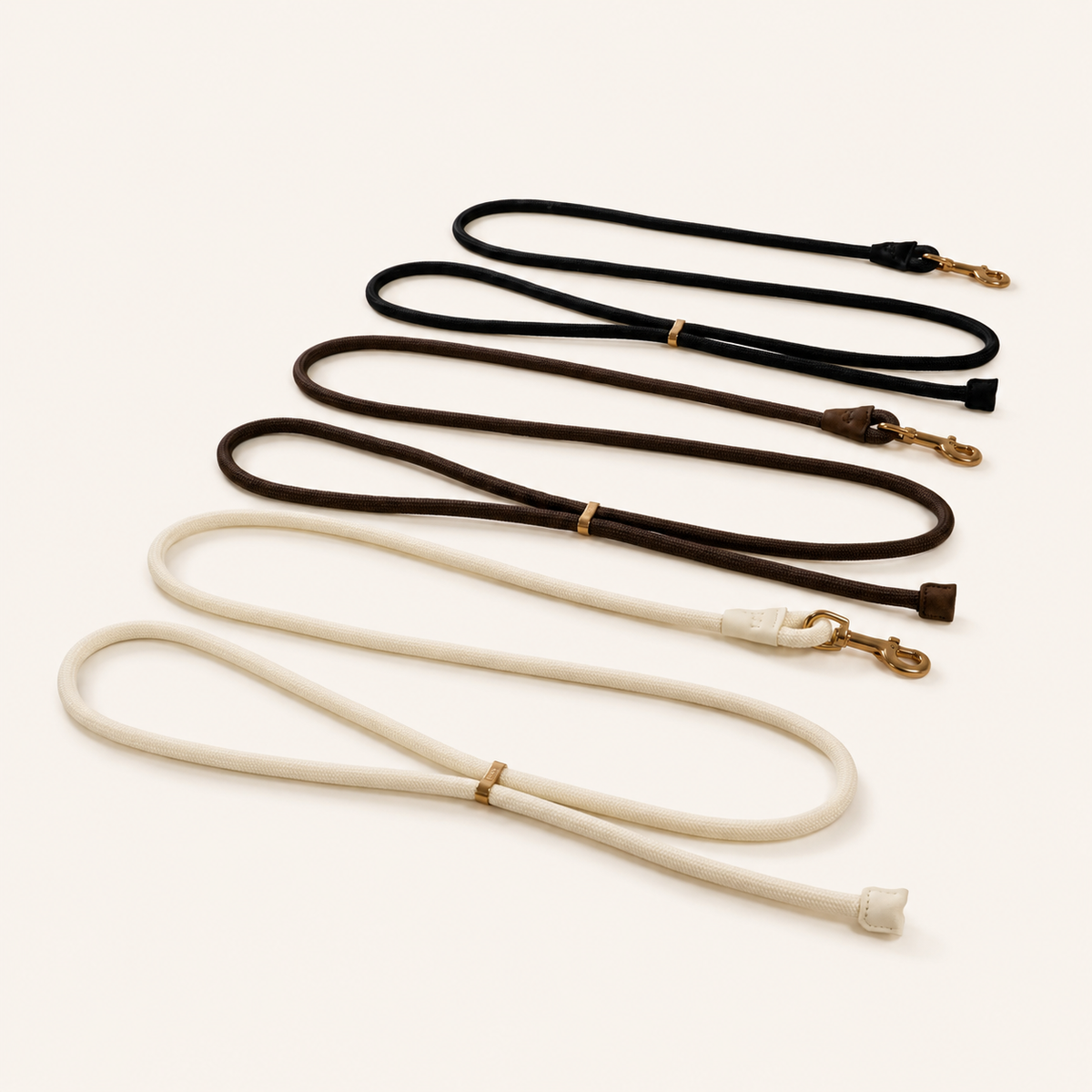 Hands-free dog leads in Bone, Cacao and Onyx with brushed gold hardware by Lé Pet Co