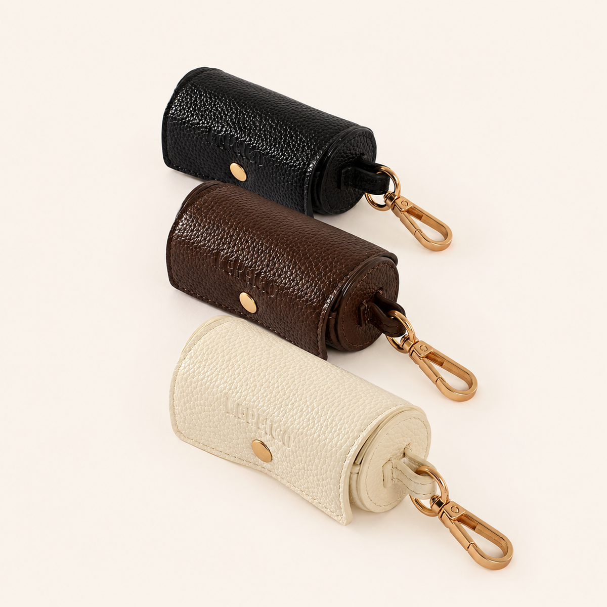 Dog poop bag holders in Bone, Cacao and Onyx with brushed gold hardware